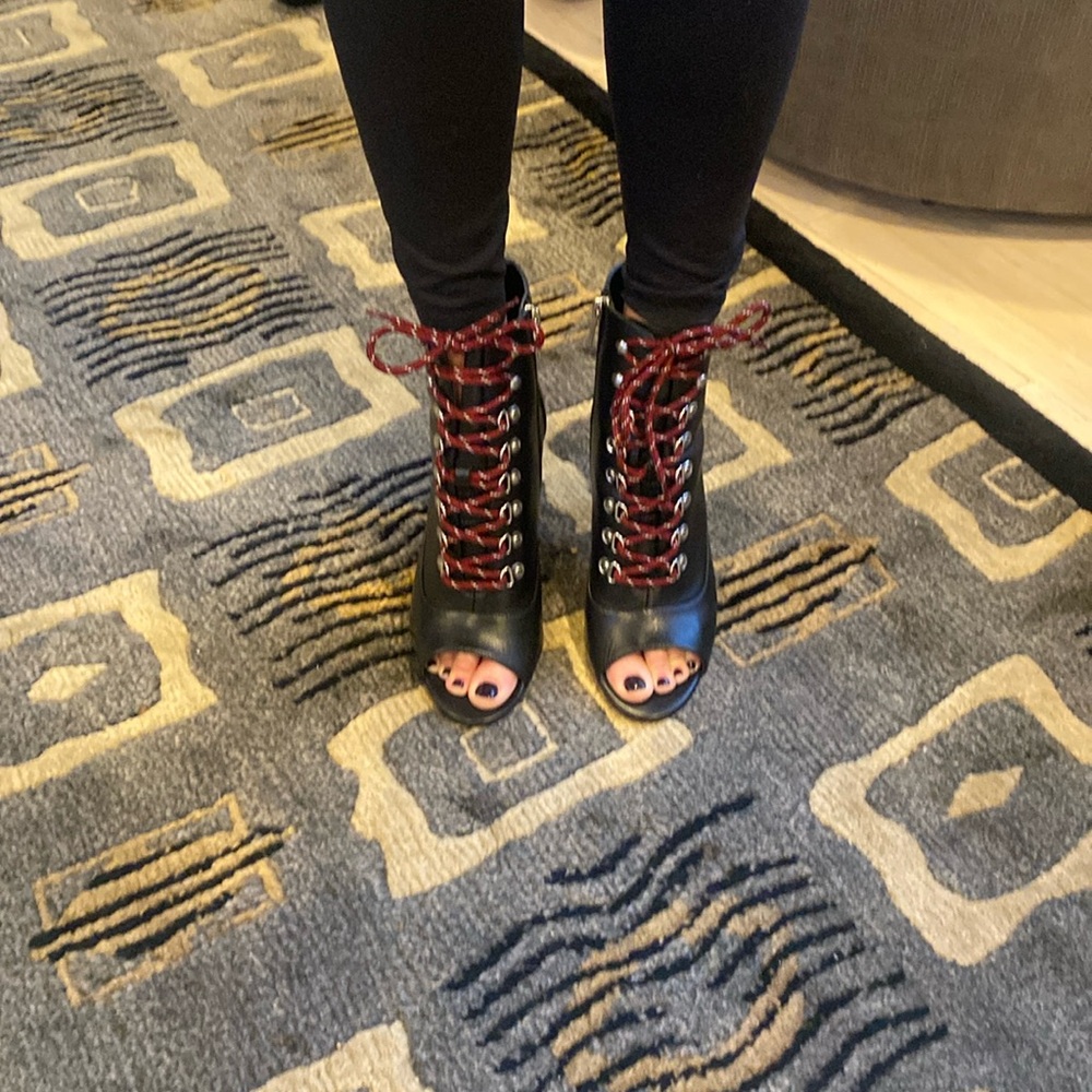 Open toe black leather ankle boots with dark red shoelaces.